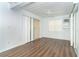 Comfortable bedroom with hardwood floors, bright window, and an air conditioning unit for climate control at 20 Palm Dr, Placida, FL 33946