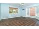 Serene bedroom featuring hardwood floors, bay windows with shades, and soft light blue walls at 20 Palm Dr, Placida, FL 33946