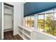 Bedroom view of shelving, closet, and window with blue blind and exterior view at 20 Palm Dr, Placida, FL 33946