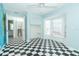 Bright bedroom with cheerful black and white checkered floor, large windows and walk-in closet at 20 Palm Dr, Placida, FL 33946