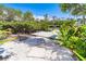 Picturesque backyard with a private dock and lush tropical vegetation, providing direct access to the water at 20 Palm Dr, Placida, FL 33946