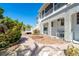 Beautiful home exterior featuring a spacious deck and well-manicured landscaping with lush greenery and brick pathway at 20 Palm Dr, Placida, FL 33946