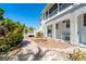 Elegant two-story exterior featuring white lattice and stairs leading to a relaxing balcony at 20 Palm Dr, Placida, FL 33946