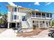 Beautiful coastal home featuring a large, screened porch and elegant staircase, perfect for enjoying outdoor living at 20 Palm Dr, Placida, FL 33946