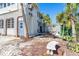Charming exterior showcasing a private entrance and well-maintained yard with mature tropical plants and stone accents at 20 Palm Dr, Placida, FL 33946