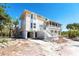 Charming coastal home featuring a screened porch and white lattice accents, creating a relaxing outdoor living space at 20 Palm Dr, Placida, FL 33946