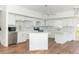 Modern kitchen features white cabinetry, stainless steel appliances, marble backsplash, and a central island at 20 Palm Dr, Placida, FL 33946