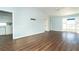 Open living room with vaulted ceiling and light blue walls with laminate wood flooring at 20 Palm Dr, Placida, FL 33946