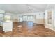 Spacious living room boasts hardwood floors, multiple ceiling fans, track lighting, and bright natural light at 20 Palm Dr, Placida, FL 33946