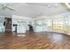 Open concept living room showcases hardwood floors, ceiling fans, kitchen access, and sunlit windows at 20 Palm Dr, Placida, FL 33946
