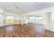 Bright living room with hardwood floors, ceiling fans, track lighting, and scenic views through large windows at 20 Palm Dr, Placida, FL 33946