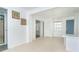 Bright living room featuring tile floors, neutral walls, and natural light from a window and sliding glass door at 20 Palm Dr, Placida, FL 33946