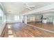 Expansive sunroom seamlessly connects to the main living area, showcasing hardwood floors and abundant natural light at 20 Palm Dr, Placida, FL 33946