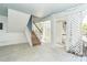 Charming staircase with wooden steps and white painted wood risers leads up to the upper level at 20 Palm Dr, Placida, FL 33946
