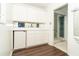 Wet bar area with refrigerator and views into the bathroom with glass shower at 20 Palm Dr, Placida, FL 33946