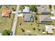 Suburban home features a pool and a large yard, surrounded by mature trees and a residential neighborhood at 23148 Corvin Ave, Port Charlotte, FL 33954