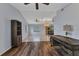 Open living space with hardwood floors, a ceiling fan, a desk, and access to the dining room at 23148 Corvin Ave, Port Charlotte, FL 33954