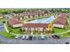 Aerial view highlighting the community with a lake, fountain, and ample parking at 25100 Sandhill Blvd # R104, Punta Gorda, FL 33983