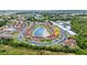 Community aerial view showcasing a central lake with a fountain and lush landscaping at 25100 Sandhill Blvd # R104, Punta Gorda, FL 33983