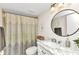 Bathroom features marble vanity and shower/tub with patterned curtain at 25100 Sandhill Blvd # R104, Punta Gorda, FL 33983