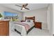 Bedroom offers large window, ceiling fan, and tile flooring at 25100 Sandhill Blvd # R104, Punta Gorda, FL 33983