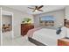 Bedroom with a TV, ceiling fan and a large window overlooking a lake at 25100 Sandhill Blvd # R104, Punta Gorda, FL 33983