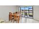 Dining area includes sliding glass door to an outdoor patio overlooking a pond at 25100 Sandhill Blvd # R104, Punta Gorda, FL 33983