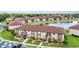 Exterior view of a two-story condo building with stairs leading to the units and a pond with a fountain in the background at 25100 Sandhill Blvd # R104, Punta Gorda, FL 33983