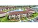 Exterior view of a two-story condo building with stairs leading to the units and a pond with a fountain in the background at 25100 Sandhill Blvd # R104, Punta Gorda, FL 33983