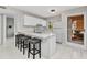 Bright, updated kitchen with white cabinets, breakfast bar, and modern finishes at 25100 Sandhill Blvd # R104, Punta Gorda, FL 33983
