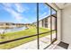 The screened lanai offers serene views of the lake and meticulously maintained lawns at 25100 Sandhill Blvd # R104, Punta Gorda, FL 33983