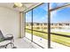 Relaxing screened-in patio with peaceful view of the pond and surrounding community at 25100 Sandhill Blvd # R104, Punta Gorda, FL 33983