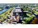 Aerial view of waterfront condo buildings with boat docks and lush landscaping at 25188 Marion Ave # F105, Punta Gorda, FL 33950