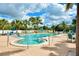 The community features a pristine swimming pool surrounded by palm trees and comfortable lounge chairs at 25188 Marion Ave # F105, Punta Gorda, FL 33950