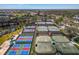 Aerial view shows the tennis and pickleball courts in the community at 3 Bermuda Cir # 49, Englewood, FL 34223