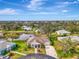 Aerial view of a well-maintained home with lush landscaping in a lakeside community at 3 Bermuda Cir # 49, Englewood, FL 34223