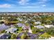 Aerial view of a charming home on a cul-de-sac with a pond view and lush landscaping at 3 Bermuda Cir # 49, Englewood, FL 34223