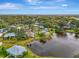 Aerial view showcases homes in community near pond and natural Florida landscape at 3 Bermuda Cir # 49, Englewood, FL 34223