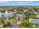 Aerial view of waterfront home featuring lush landscaping and a tranquil lake setting at 3 Bermuda Cir # 49, Englewood, FL 34223