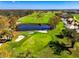 Aerial view of the golf course, showcasing the water feature and sand traps at 3 Bermuda Cir # 49, Englewood, FL 34223