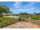 Beautiful brick patio with a wrought iron fence overlooking the lake at 3 Bermuda Cir # 49, Englewood, FL 34223