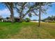 Expansive backyard with mature trees and views of the lake at 3 Bermuda Cir # 49, Englewood, FL 34223