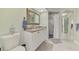 Bathroom with a shower, vanity with granite top, and framed mirror at 3 Bermuda Cir # 49, Englewood, FL 34223