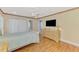 Bedroom featuring wood floors, neutral walls, closet and modern dresser at 3 Bermuda Cir # 49, Englewood, FL 34223