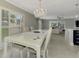 Dining room, living room, and kitchen open concept with lots of natural light at 3 Bermuda Cir # 49, Englewood, FL 34223
