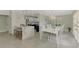 Light and airy dining room with view of the kitchen bar and seating at 3 Bermuda Cir # 49, Englewood, FL 34223