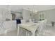 Bright dining room with stone topped kitchen bar in the background and open layout concept at 3 Bermuda Cir # 49, Englewood, FL 34223