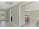 Bright entryway with tiled floors, view to kitchen, and storage, leading into the rest of the house at 3 Bermuda Cir # 49, Englewood, FL 34223