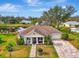 Beautiful single-story home with a well-manicured lawn, picturesque pond view, and inviting curb appeal at 3 Bermuda Cir # 49, Englewood, FL 34223
