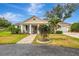 Charming single-story home featuring a well-manicured lawn, beautiful columns, and a welcoming front porch at 3 Bermuda Cir # 49, Englewood, FL 34223